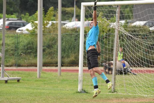A football player jumping and trying to catch a ball