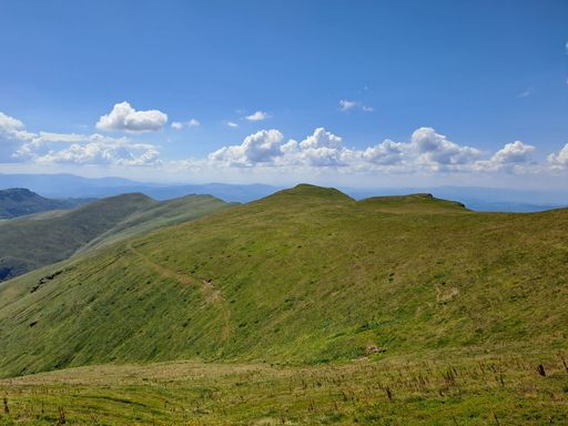 A beautiful scenery of a green mountainous landscape in blue sky background in sunlight