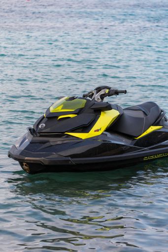A vertical shot of the black and yellow jet sky in the sea during the daytime