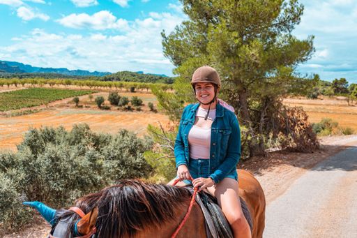 A shallow focus shot of a young female riding horse