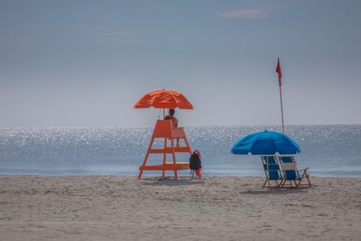 The lifeguard sitting on the chair in the Myrtle sandy beach, South Carolina