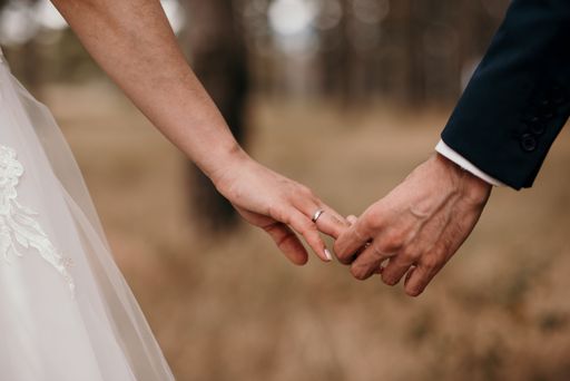 The newly married couple holding hands