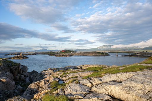 A beautiful scenery of bridges over the Atlantic Road scenic route and a calm sea under a cloudy day