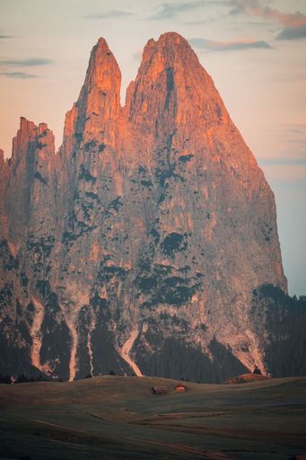 A vertical shot of the beautiful rocky mountains of South Tyrol against a cloudy sky during the sunset
