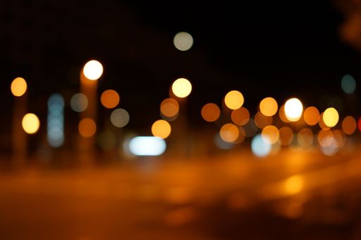 A blurred night street background with bokeh lights