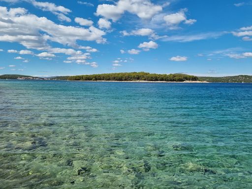 A scenic view of the crystal clear sea on a sunny day in Zmajan, Croatia