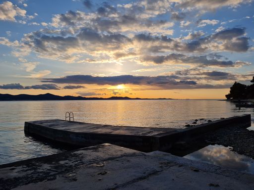 A sea reflecting the beautiful sky during golden hour