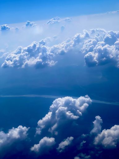 A vertical shot of the beautiful cloudscape in the blue sky.