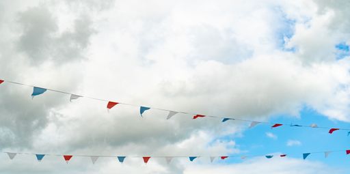 A selective of bunting decorations against the blue sky with white clouds