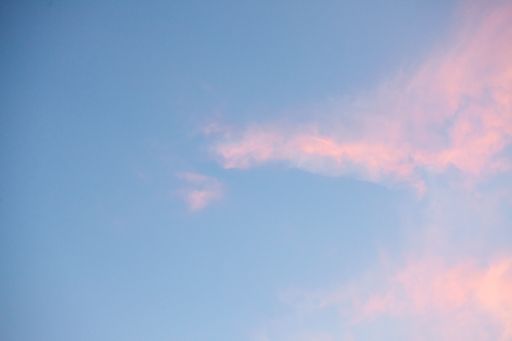 A low angle shot of the calm sky in pastel shades with a few clouds - perfect for a wallpaper