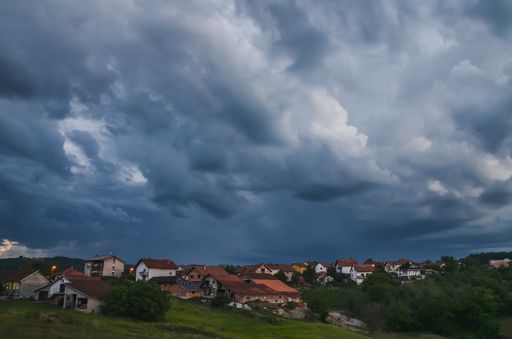 An amazing shot of a village on a stormy sky background