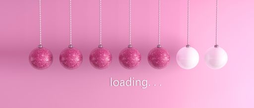 A closeup shot of balls and writing "loading..." on pink background