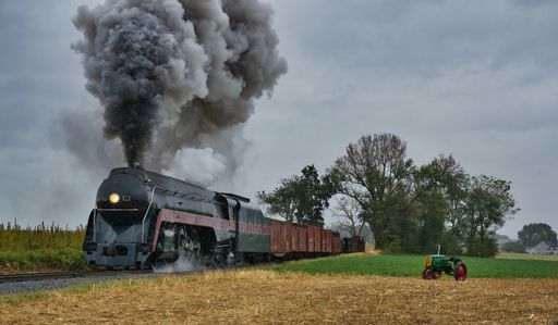 An antique steam train engine puffing
