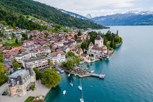 An aerial view of the Oberhofen Castle and the coastal city in Switzerland