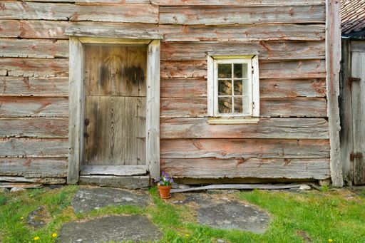 An old wooden barn in a field under the sunlight at daytime