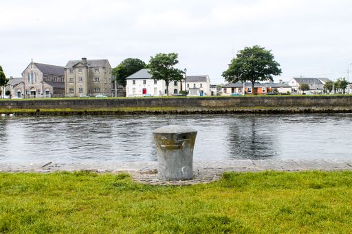 A low-angle view of modern buildings near the river in Galway, Ireland