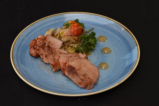A closeup shot of steak with vegetable sidedish isolated on a black background