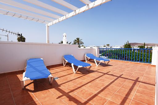 The deck chairs at the pool area on a sunny day