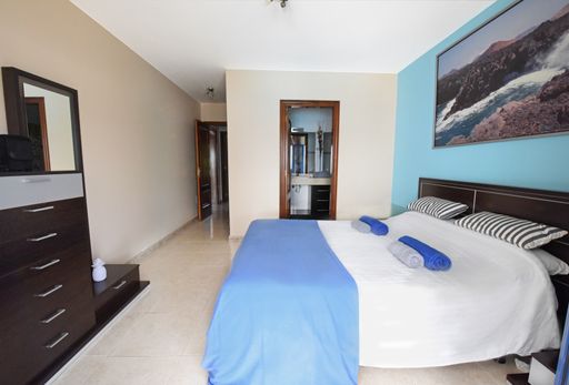 A cozy bedroom in the hotel room during the daytime
