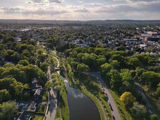 An aerial shot of the Clifton Park in New York City with the sun shining in the background