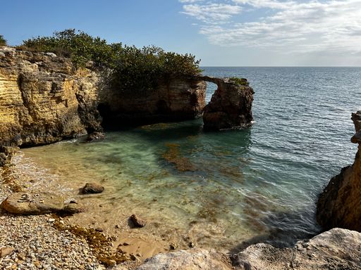 A Rock bridge over the sea on a sunny day