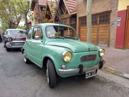 Bernal, Argentina - Sept 18, 2022: old green 1970s Fiat 600 sedan two door rear engined unibody parked in the street. Classic car show.
