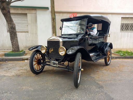 Bernal, Argentina - Sept 18, 2022: Vintage black 1910s Ford Model T taxi cab double phaeton parked in the street. Classic car show.