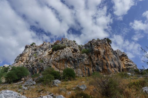 view of a granite mountain used in climbing with cloudy sky in the background