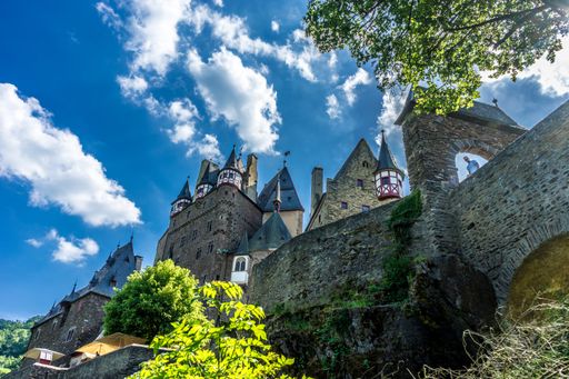 A low angle shot of the Eltz Castle surrounded by trees in Wierschem, Germany
