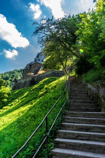 A beautiful shot of the stairs leading to Eltz Castle surrounded by trees in Wierschem, Germany