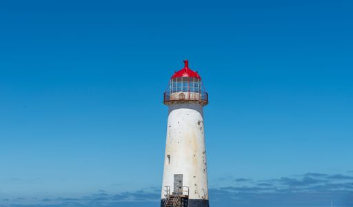 A beautiful view of an old lighthouse under the clear sky