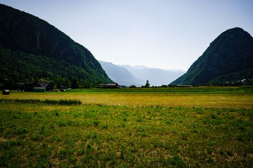 A landscape  of tipical countryside with green field between mountains in Slovenia