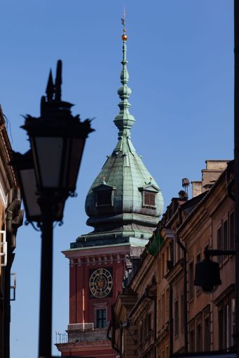 A vertical shot of the Lamp and copper roof tower in old town market square, Warsaw, Poland