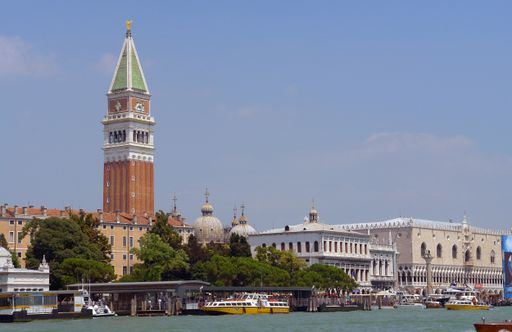 The bell tower in Saint Mark's Square and the front of the Doge's Palace, viewed from across Saint Mark's Basin, at the mouth of the Grand Canal.