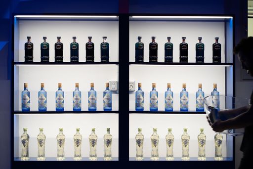 An illuminated display with expensive bottles of alcohol at Milan Fashion Week