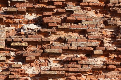 A closeup shot of old crumbling bricks in a wall