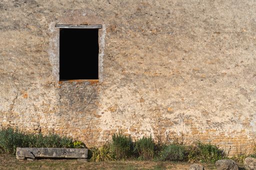 An abandoned brick buildings with window opening