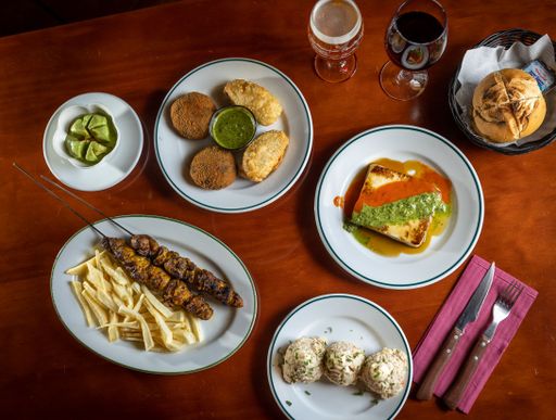 A top shot of a homemade breakfast table with vegetable cutlets, french fries and other delicious food