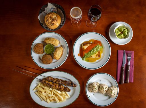 A top shot of a homemade breakfast table with vegetable cutlets, french fries and other delicious food