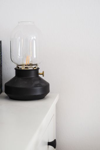 A vertical shot of IKEA's Tarnaby Table Lamp on the white furniture modern house interior