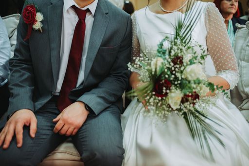 A groom and bride holding her bouquet on a wedding day