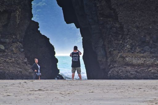 Auckland / New Zealand - March 10 2019: Photographer takes a picture at the Piha Keyhole