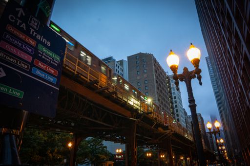 A low-angle shot of high subway public transportation rail train in Chicago city at night