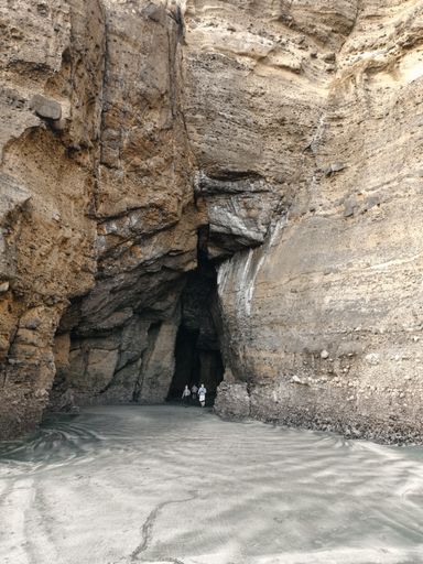 Auckland / New Zealand - April 20 2019: Group of scientists walk around Piha Blowhole cave