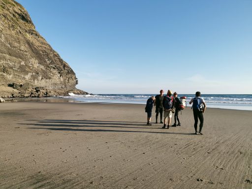 Auckland / New Zealand - April 20 2019: Group of scientists walk around Piha Blowhole cave