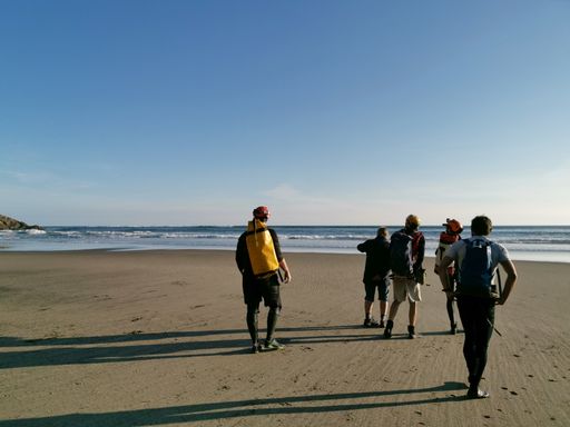Auckland / New Zealand - April 20 2019: Group of scientists walk around Piha Blowhole cave