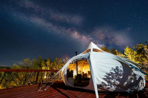 A glamping tent against a starry night sky