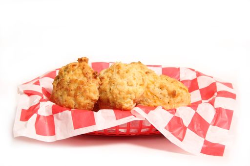 Garlic and Cheddar Biscuits in a Basket Isolated on White