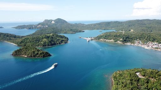 Aerial top view of the scenic seascape, lagoon and coral reef with turquoise water, small waves before storm on island in Philippines