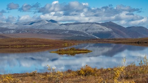 Yukon in Canada, wild landscape in autumn of the Tombstone park, reflection on the lake